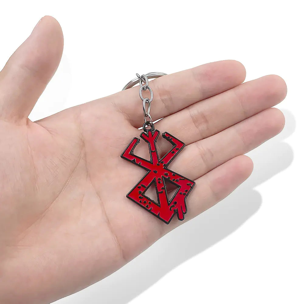 Windblade pendant close-up - Red and black keychain held in a hand 